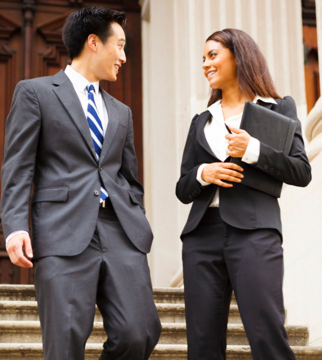 Legal professionals walking together outside a courthouse
